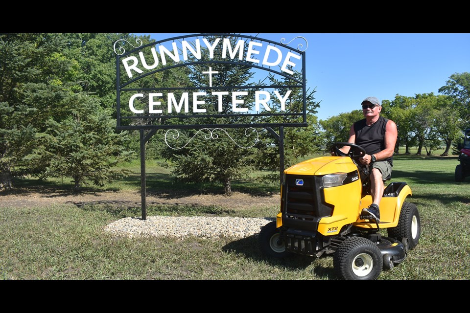Since June, Norm MacDonald, assisted by his wife Brenda, has been tending to the Runnymede Cemetery. In addition to assuring that the grass is cut and removing old limbs from surrounding trees, the MacDonalds have been cleaning and straightening headstones and will be using a load of soil to refill depressions.