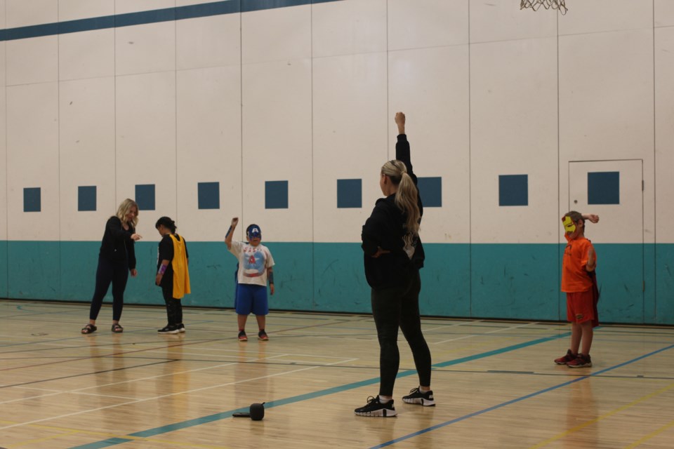 Summer Fun program participants practice dance with facilitator, Lauren Denysek.