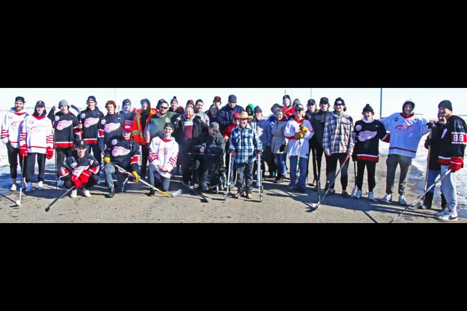 The Weyburn Red Wings gathered with everyone from the Weyburn Wor-Kin Shop for a group photo at the end of the road hockey game on Thursday.