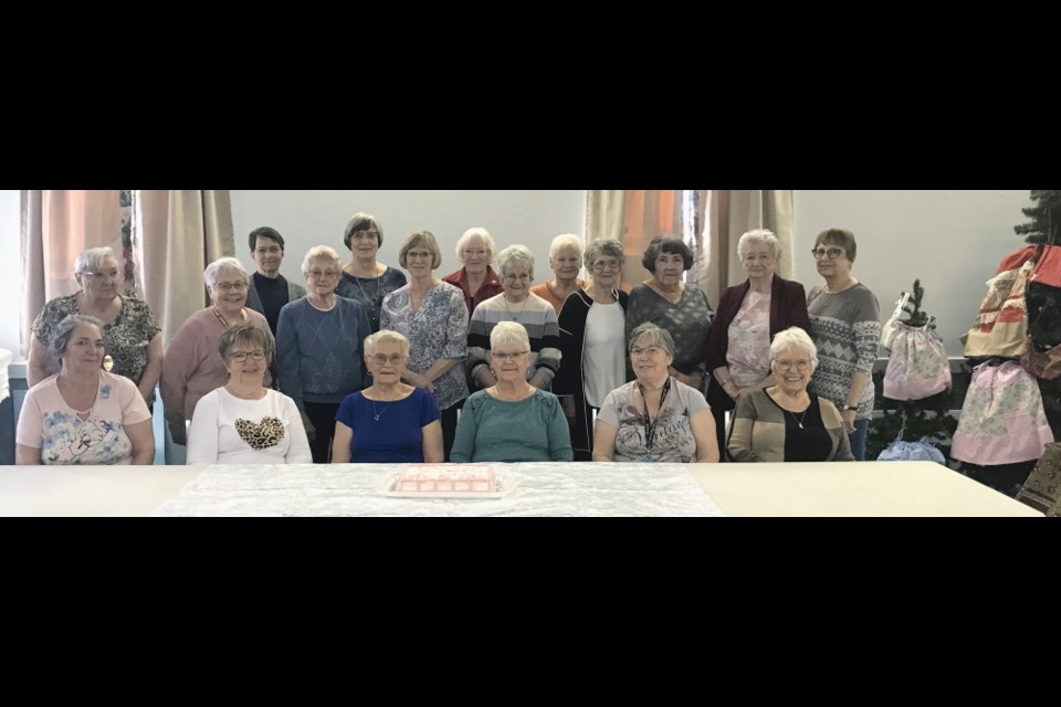 A group of women gathered to celebrate 10 years of making little dresses. 