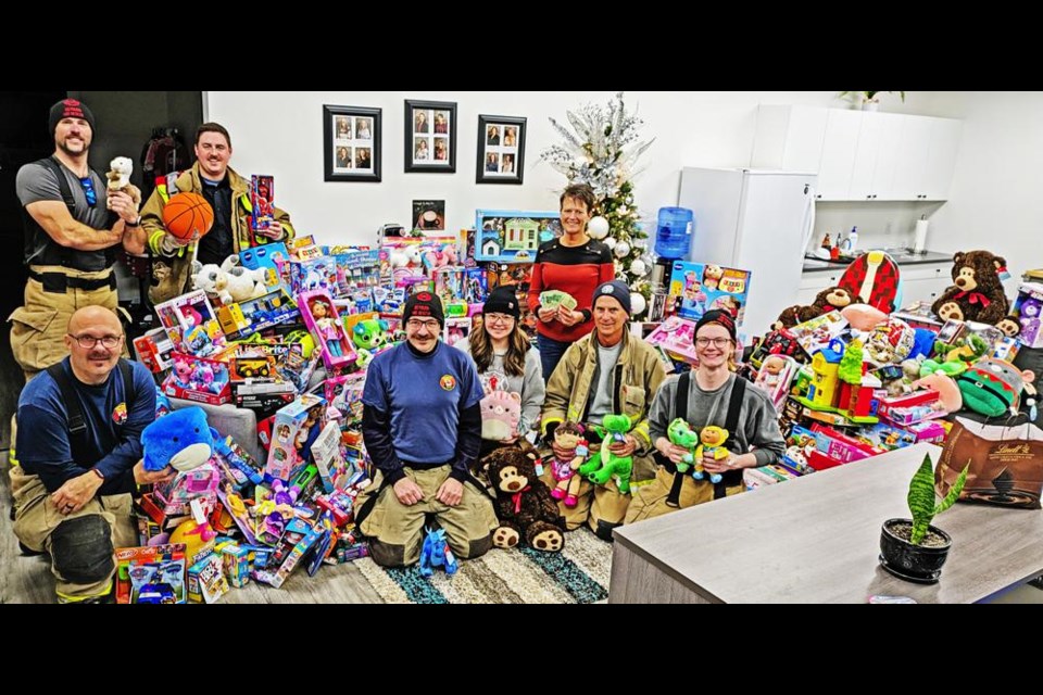 Weyburn fire fighters gathered with all of the toys and around $800 in cash donations after bringing it all in to the Family Place on Saturday afternoon, after holding a toy drive at Peavey Mart and Walmart.