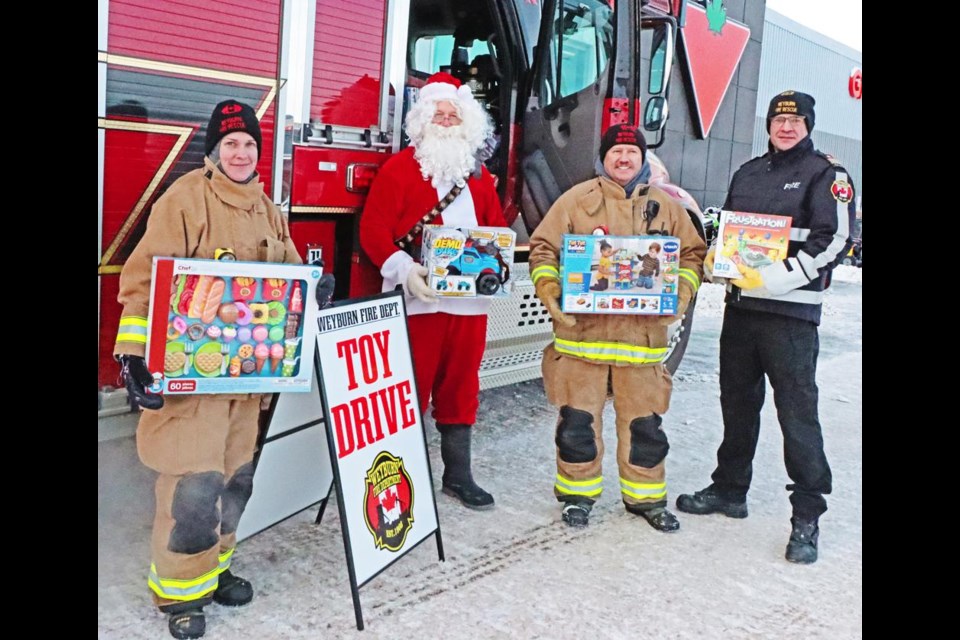 The Weyburn Fire Dept. held their annual Toy Drive on Saturday, including Kelsey Arnott, Santa, Charles Hignett and chief Trent Lee, set up at the Canadian Tire store. A second truck was at the Wal-Mart store, and all of the toys were taken over to the Family Place, with Santa's help.