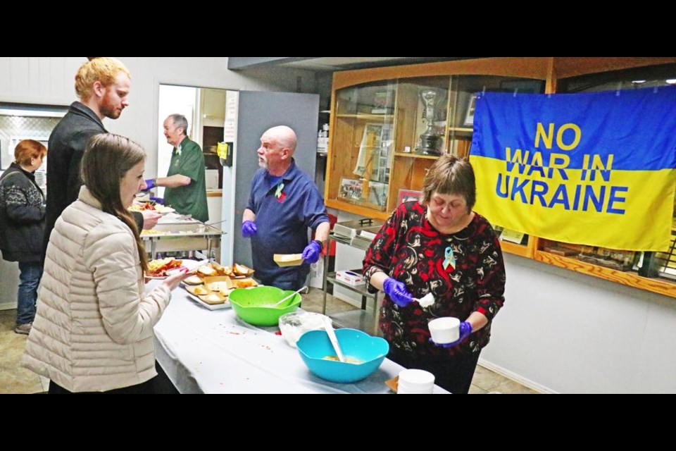 Debbie Kater served up a fruit cocktail as part of a fundraiser brunch on Saturday at the Weyburn Legion Hall to help refugees who are displaced in Ukraine. Also helping to serve at the brunch are Jerry Ponto and Brian Glass, with the event organized by members of the Ukrainian community in Weyburn.