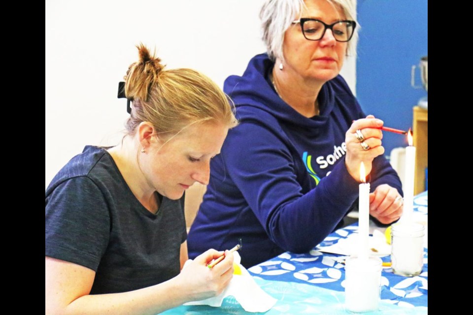 Paloma Fenn and her mother, Renata Proszak, worked on their Ukrainian Easter eggs, during a class at the Weyburn Public LIbrary on Saturday.