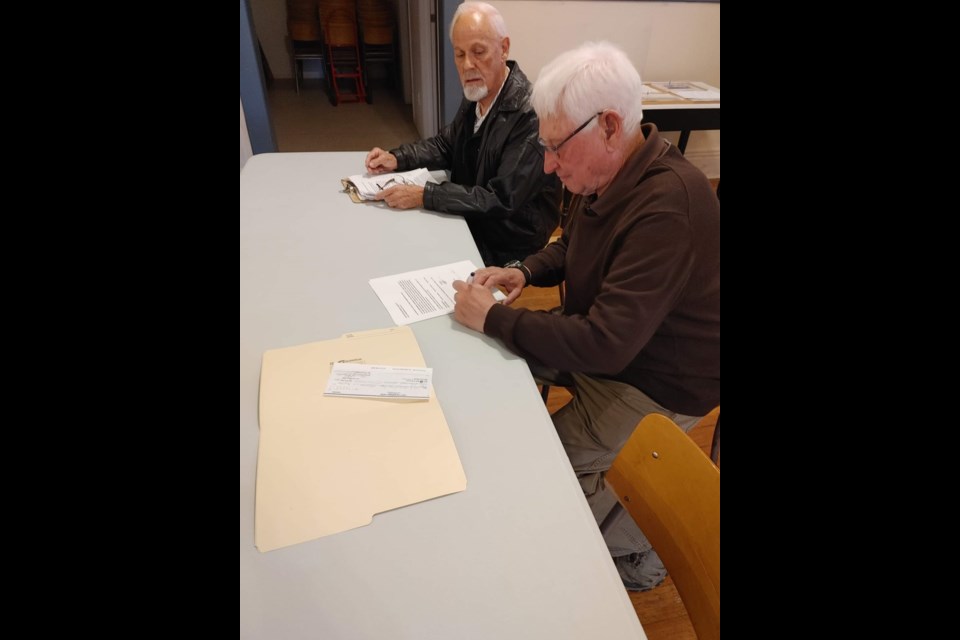 Unity Mason members, Byron Trapp and Ed Houser, sign over their lodge and memorabilia to the Unity Museum at the close of their tenure as a service club in Unity.