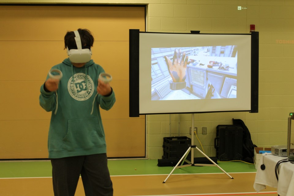 An attendee of the career expo practices an HVAC scenario.  The VR simulation was presented by the Regina District Industry Education Council who work closely with Regina Work-Prep and Careers Labs VR to