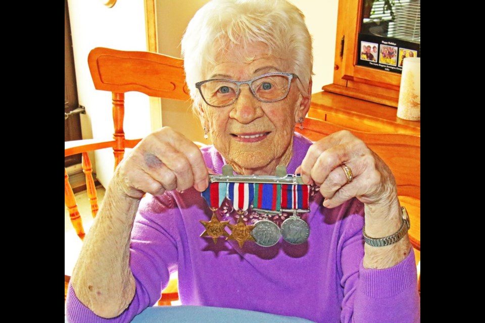 Frieda Lillejord displays the medals earned by her late husband Melvin, for serving with the South Saskatchewan Regiment during the Second World War