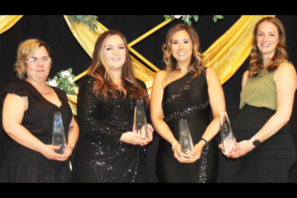 The four award winners for 2023 gathered onstage after the presentations. From left are Kendra Sutherland, Exceptional Entrepreneur Award; Jordan Szczecinski, Community Service Award; Tamara Seghers, Workplace Excellence Award; and Alex Clarke, Young Woman of Distinction Award.