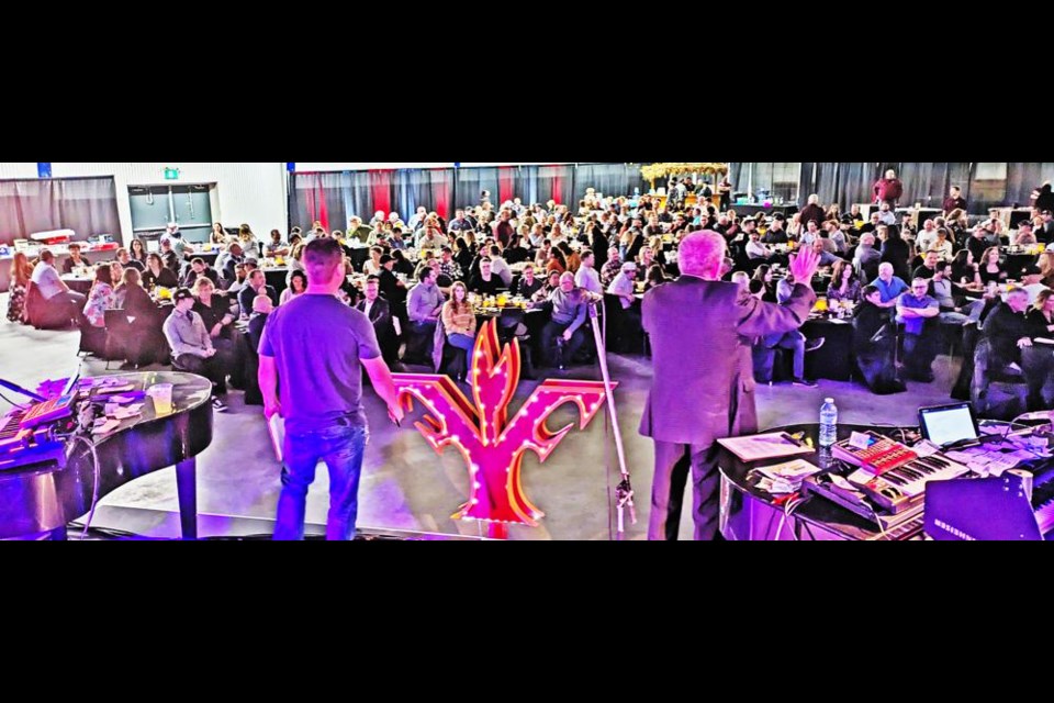 Jeff Tosczak and Winston Bailey scanned the crowd of 320 people for bids, during the live auction of 19 items in addition to the 494 silent auction items, for the Young Fellows Club of Weyburn.