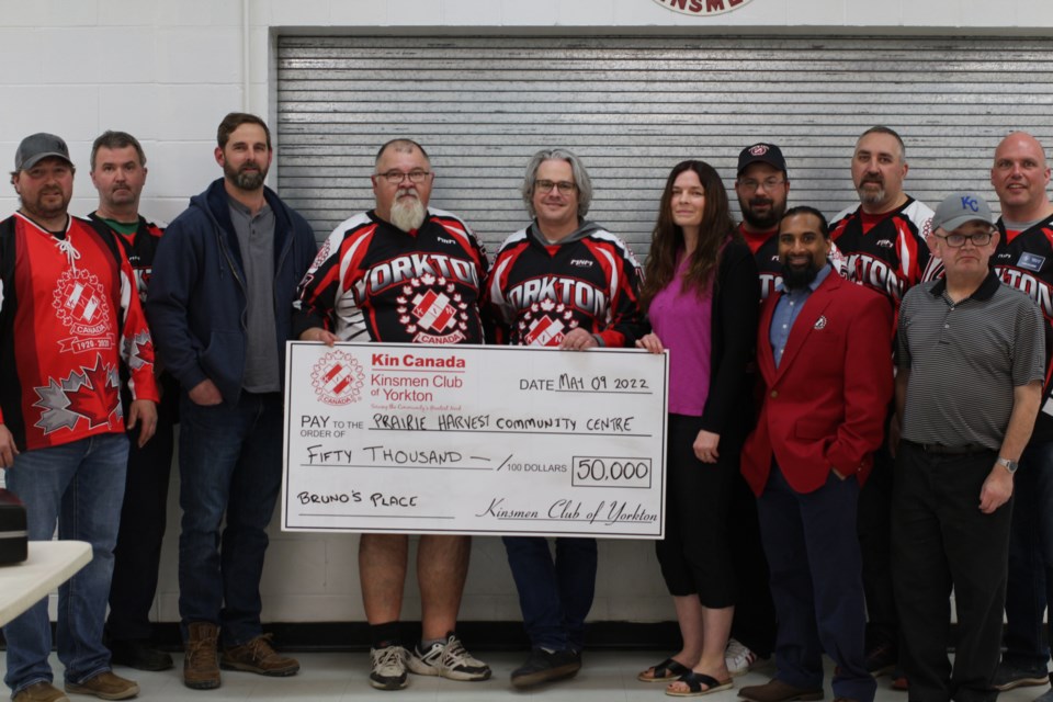 Members of the Kinsmen Club present Stephan Bymak and Angela Chernoff of Prairie Harvest Community Centre with a cheque for $50,000.  