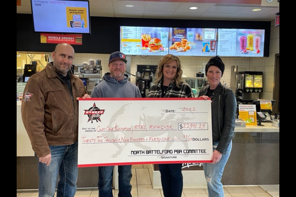 Jodi and Corey Chmelnyk present a cheque to Alan and Jennifer Cave of the Colby Cave Foundation.
