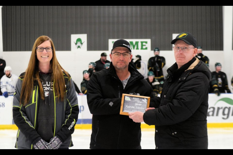 Lori Fenrich, left, and Mayor David Ziegler, right, surprised the 2021 Wilkie Citizen of the Year, Aaron Sittler, centre, pulling him out of the scorekeeper’s booth to accept the award at game 2 of the SWHL final between the Wilkie Outlaws and Macklin Mohawks, March 18. 