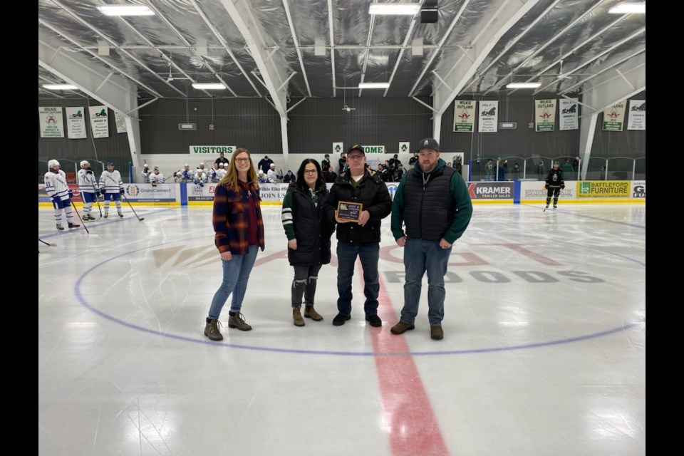 Jill and Travis Thomson, Wilkie's 2022 Citizens of the Year, awarded at March 17 Outlaws playoff game.