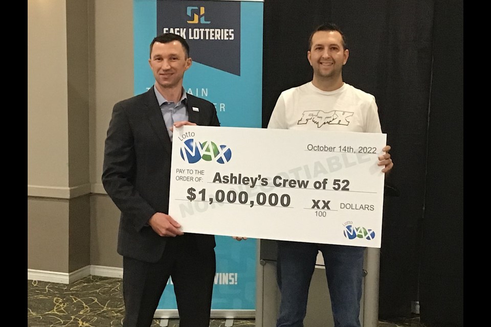 Ashley Sieben of Langenburg accepts the $1 million cheque from Michael Rogers of Sask Lotteries.
