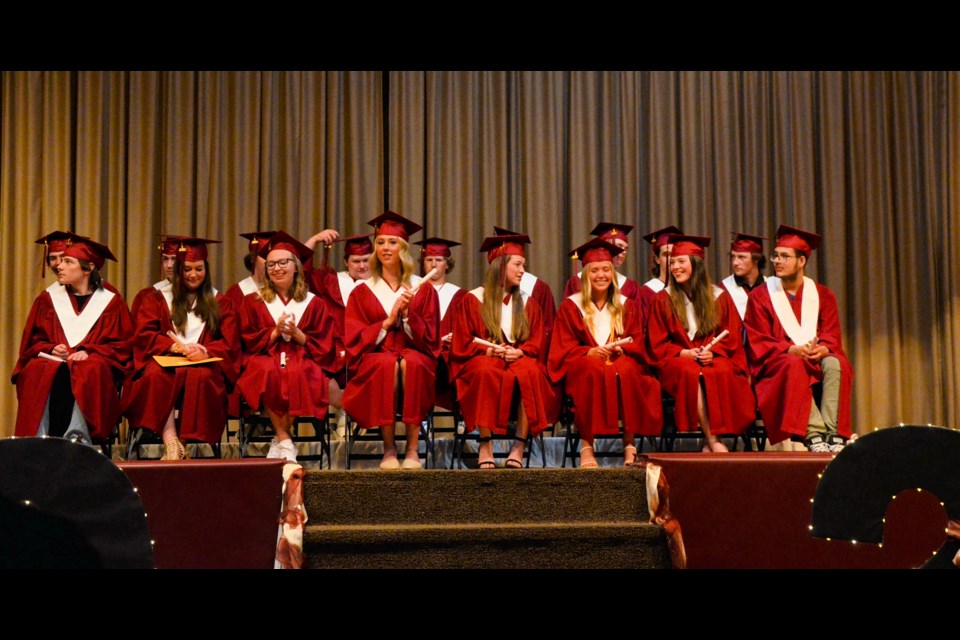 Members of the McLurg High School Class of 2024 react to the words of their principal, who was at the podium.