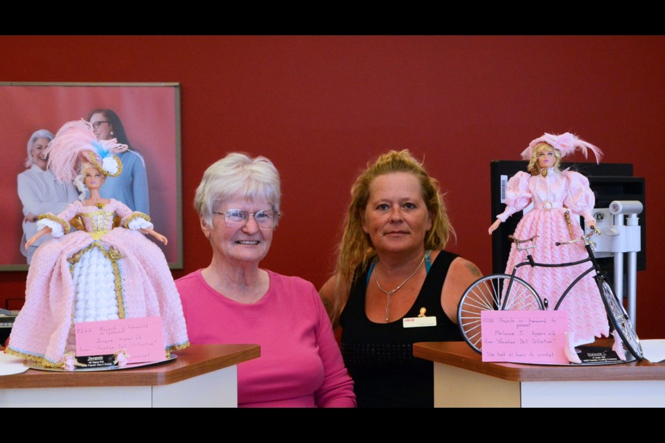 Doll-maker Donelda Allen and Wilkie CIBC employee Helen Urlacher pose with two dolls Allen has donated to the Wilkie CIBC’s Run for the Cure silent auction. Wilkie CIBC is raising funds for research and for financial assistance for Wilkie resident and breast cancer patient Carolyn Eremko.