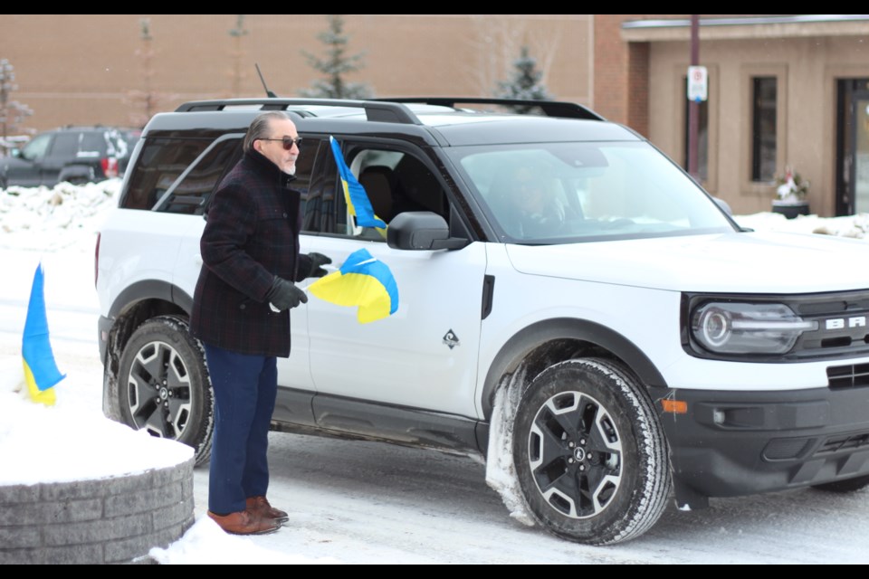 Vehicles waiting at the stop lights were requesting flags from Greschuk. 