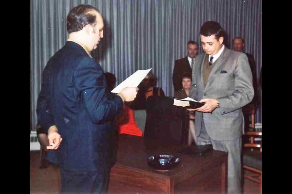 Alex Miles is being sworn in for his first term as alderman in 1970; he served on city council from 1970-73, and 1977-79