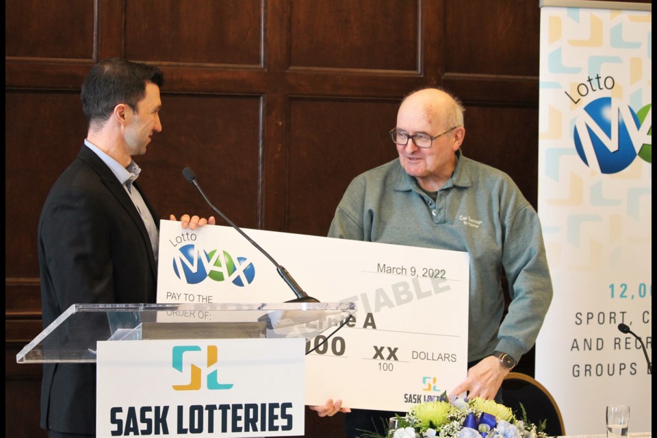 Ernie Anuik, right, accepts his $20 million cheque from Sask Lotteries vice-chair of lotteries Michael Rogers, as the province's most recent big winner.