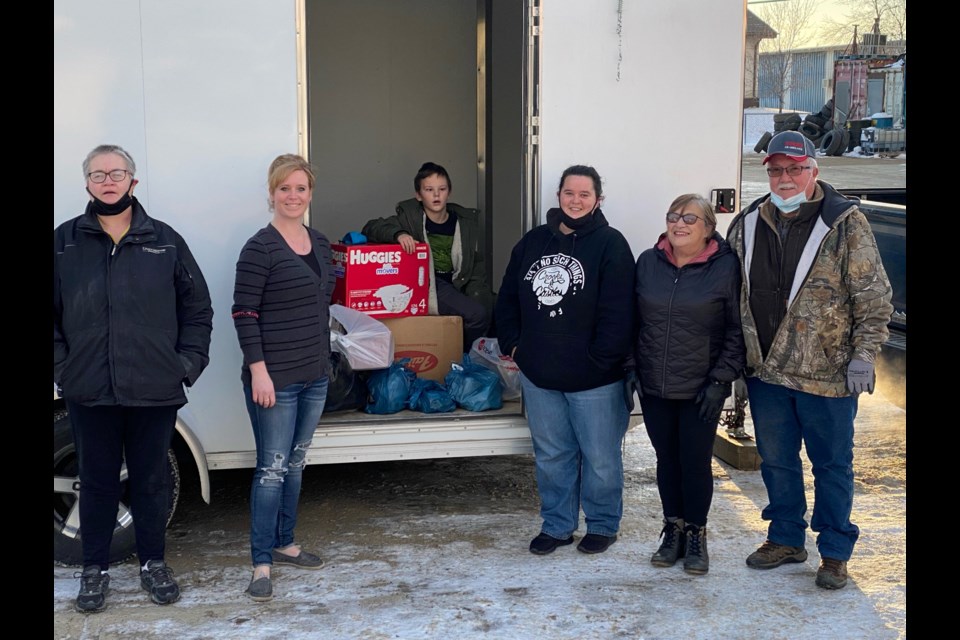 Theresa Keller, Sara Neil, Lyndsay Soderholm and Sharon and Terry Smith stand with the trailer that is being loaded to take to drop off point for B.C. relief effots.