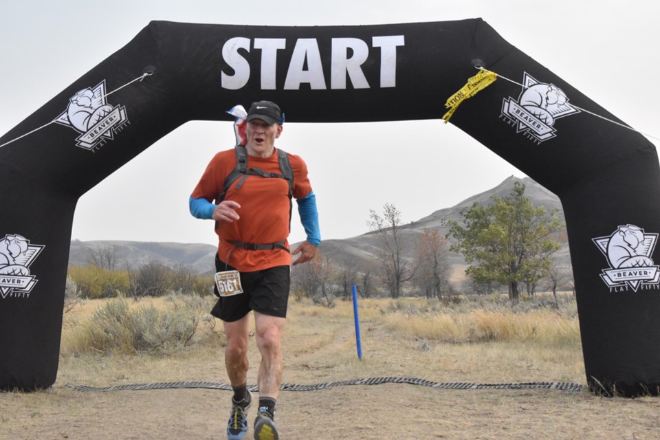 Most Rev. Bishop Mark Hagemoen slows down after crossing the finish line in last Saturday's Beaver Flat 50K run at Saskatchewan Landing Park.