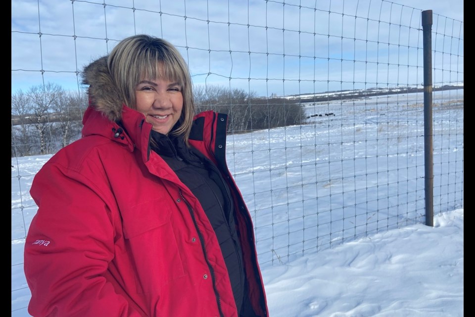 Chief Tanya Stone, of Mosquito, Grizzly Bear's Head, Lean Man First Nation, shown near the large bison compound area. 