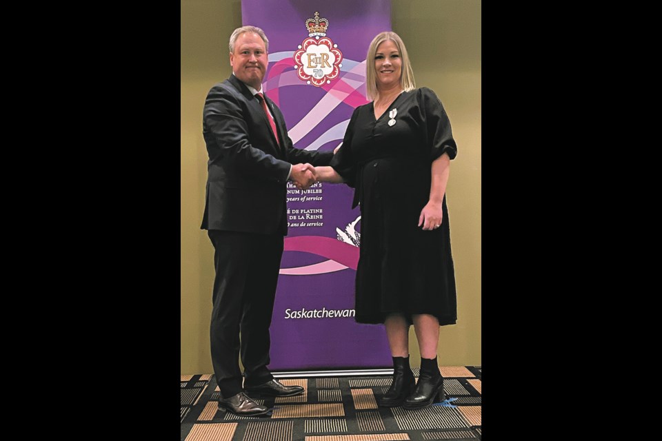 Kerrobert Composite School principal and Luseland resident Candice Kraft receiving her medal from MLA Ken Francis.