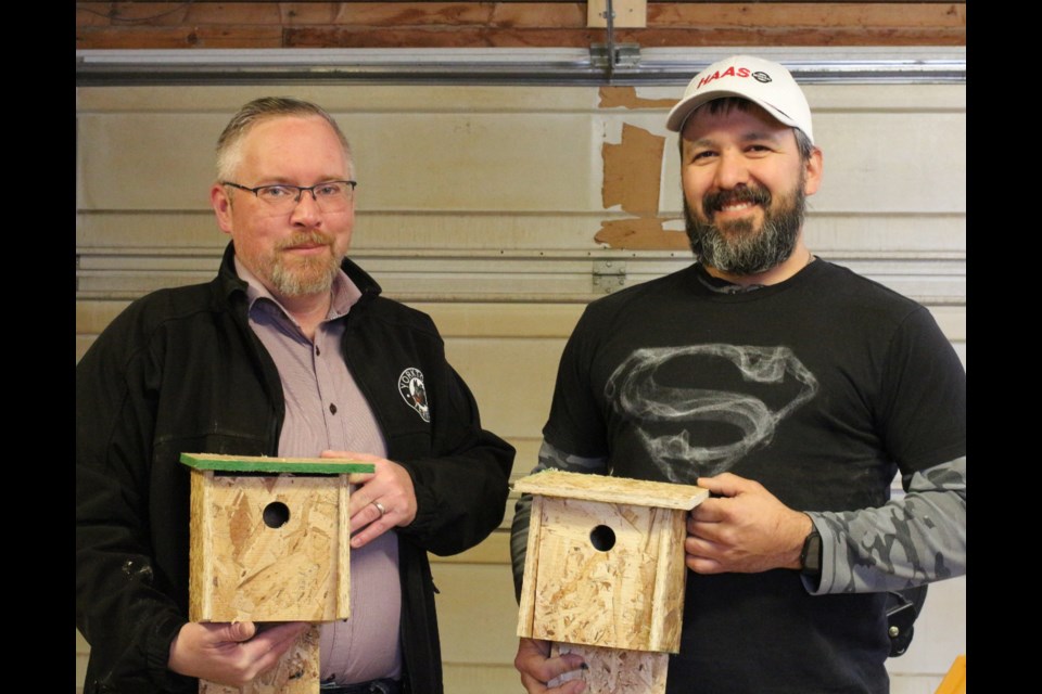 Scott Sharpe (left) and Theron Smith (right) are continuing with the volunteer efforts of a departed friend.