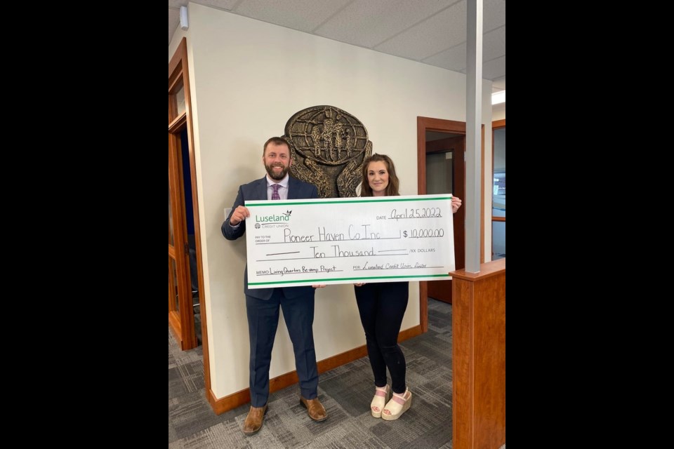 Luseland Credit Union CEO Adam Franko happily presents $10,000 to Kerrobert Pioneer Haven manager, Krystal Bazlynski towards their fundraising goals for updates ongoing in 2022.