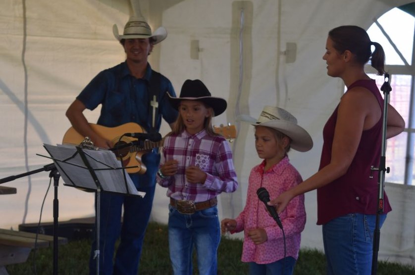 Kelvin and Jessica Young and their family shared their musical talents during Cowboy Church on Aug. 21. From left, were:  Kelvin, Emma (10), Thea (8) and Jessica.