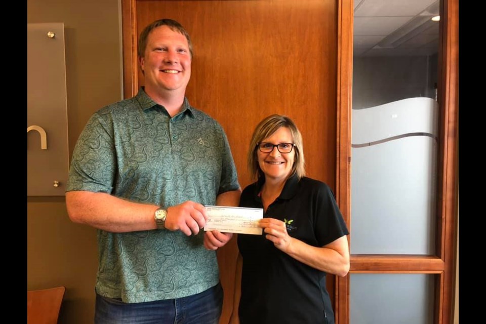 On behalf of the Cut Knife Recreation Board, Mike Wismer accepted a $1,000 donation from the Cut Knife Royal Purple, presented by Twyla Loranger.