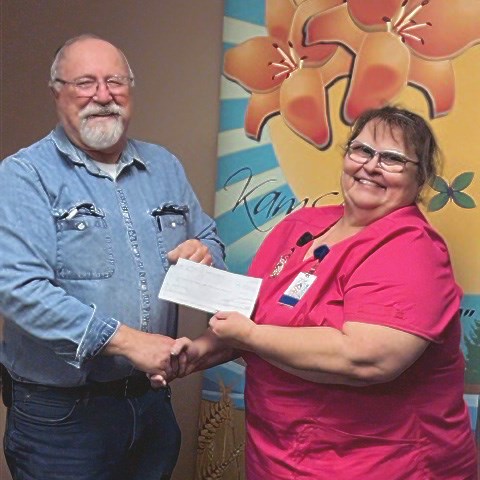In a gesture of community support, local businessman Rick Aikman presented a donation of $8432.25 to Cindy McGregor, the manager of Eaglestone Lodge, on behalf of The Men's Club of Kamsack. The contribution was for capital expenses associated with the upkeep and improvement of the Lodge.