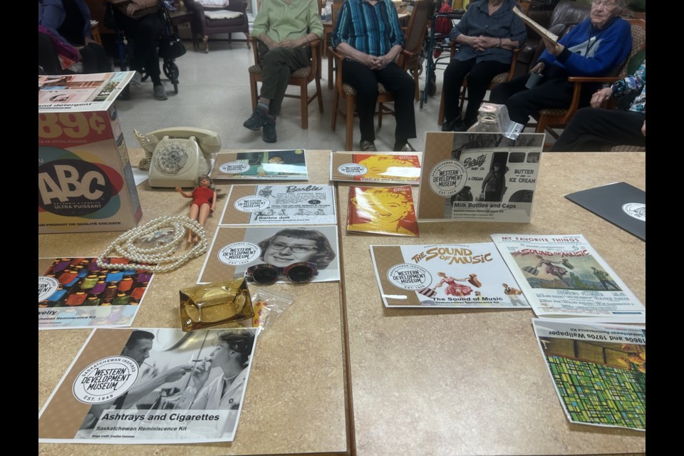 Various items were brought to Eaglestone Lodge for Memory Day, including vintage sunglasses, an old box of ABC cleaning detergent, a rotary phone, a Barbie, and a pearl necklace, among other items.