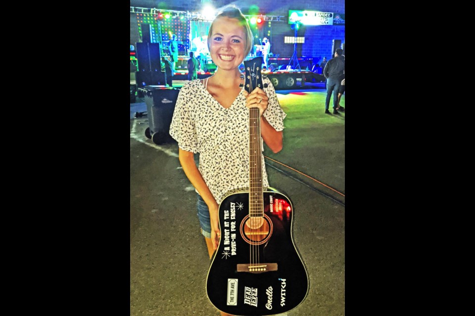 Ensley (Akins) Peters was all smiles as she was presented with this guitar at a fundraiser concert held for her in 2020.