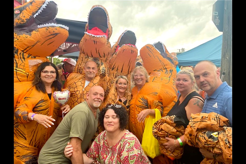 Caroline Saxon, left, and Joanne Choma, third from right, of Estevan, met tourists from Liverpool, UK, who came to Dundurn to partake in setting the Guinness World Record in the Dino Challenge on July 1.