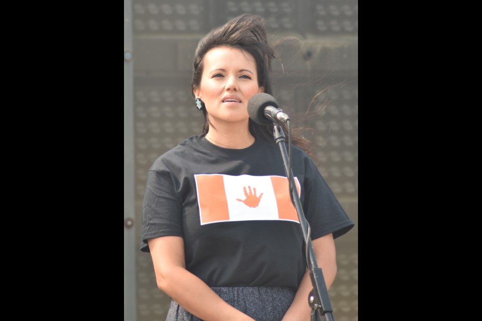 Falynn Baptiste sings the Canadian National Anthem in Cree during the unveiling of a flag honouring all Indigenous children who lost their lives in residential schools last month at Marquis Downs Racetrack.