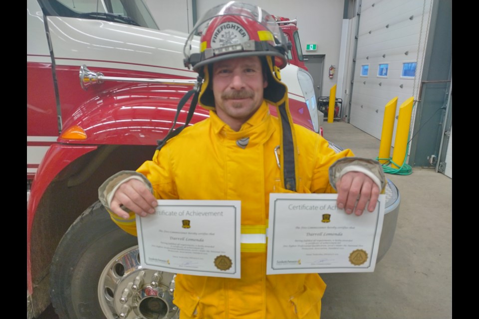 Firefighter Darrell Lomenda with his certificates.