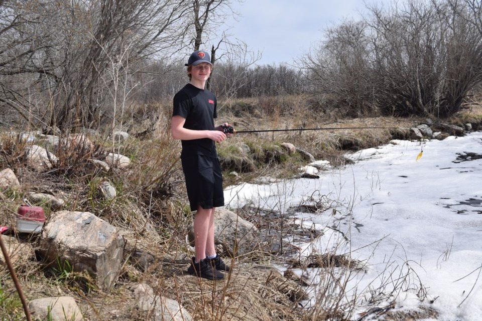 Logan Lewchuk of Canora took advantage of the warming temperatures and found himself a good spot for some fishing at the Canora Dam on May 11.