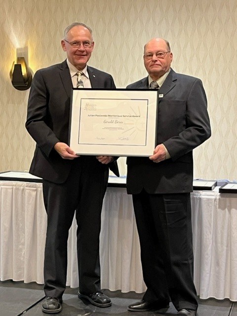 Right, Gerald Beres, receiving an award for his dedication in service on the board of Light of Christ Catholic School Division.