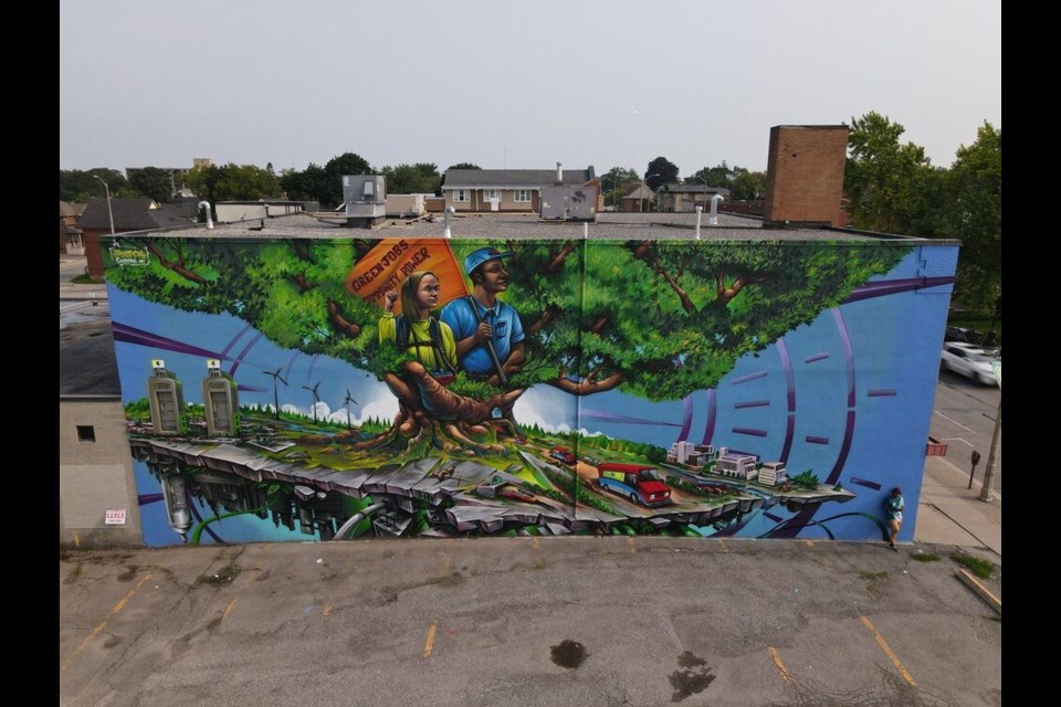 A new mural in downtown Oshawa depicts the city’s vision of a just transition and was created by Bruno Smokey of Clandestinos Art.