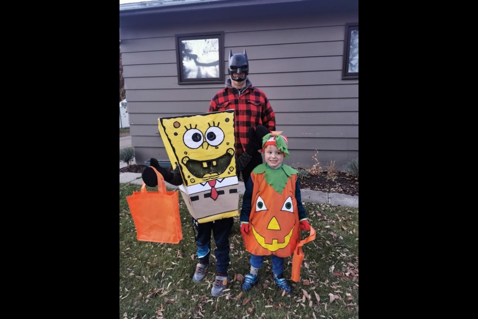 Many Canora residents went all-out for Halloween this year, whether it was in scary yard decorations or creative costumes, or both. Lucas Nicholson (SpongeBob SquarePants) and his brother Silas (The Great Pumpkin) were all fired up for some quality trick-or-treat action around town, but first they joined their father Robert (Batman) for a quick photo.  / Kulchera Nicholson