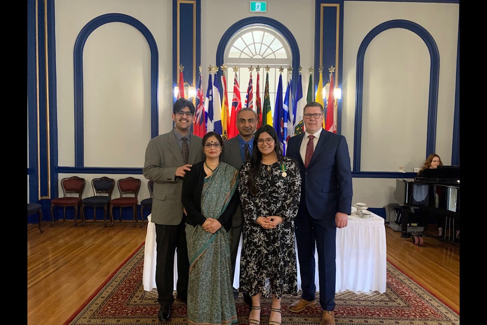 Ishita Mann and her family with Premier Scott Moe.