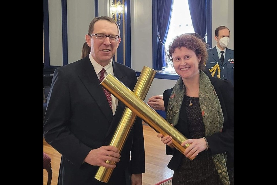 David Bishop, left, showed his official royal commendation certificate along with Kaylea Dunn, Q.C., who is a partner at McKercher LLP in Saskatoon.