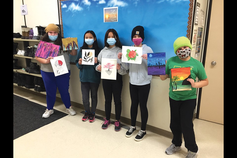 Notre Dame students Zadie, Ysabell, Shelvie, Rebeka and Nolan show off the art they created. 
