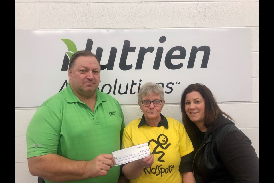 Unity Nutrien locaiton manager Lindsay Gampe presents proceeds from fertilizer fundraiser to Unity KidSport committee members Arlene Southgate and Nicole Headrick.