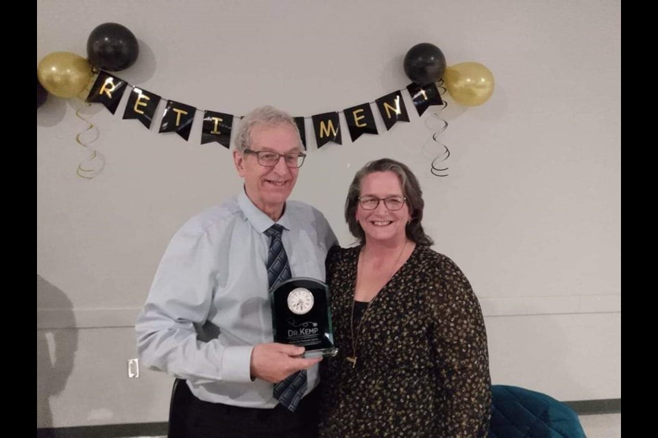 Tina Drummond, Administrative Assistant for Prairie Sky Recovery Centre, presents Dr. Kemp with engraved clock.