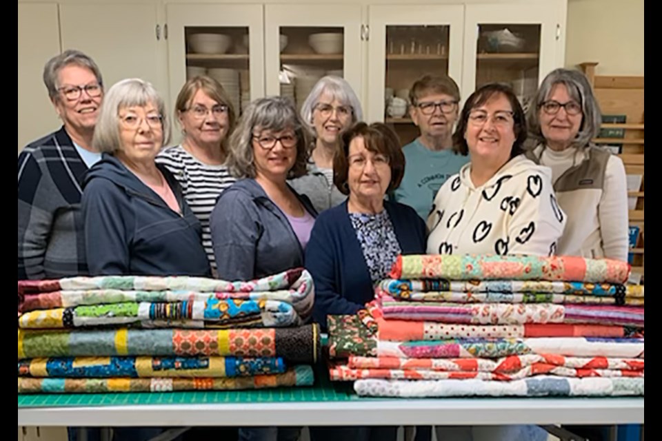 A Common Thread, a Canora and area quilting group, made another 12 quilts for donation to Ronald McDonald House in Saskatoon as this year’s quilting project. Group members, from left, are: (back row) Janet Hill (Yorkton), Julie Kraynick (Canora), Karen Kraynick (Canora), Kathleen Harris (Canora) and Mary Cushway (Hampton); and (front) Oney Pollock (Canora), Denise Morton (Good Spirit Acres), Gladys Tomski (Crystal Lake) and Renee Langan (Canora).
Group members unavailable for the photo are: Doris Kopelchuk (Canora), Carolle Pasiechnik (Canora) and Susan Wrubell (Yorkton). 
The group undertakes one charity quilting project per year. 
“Each quilt takes a minimum of 10 hours- often many more,” said Pollock. “We have made Ronald McDonald House our charity for now. A new one is being built in Regina and plans are in place for one in Prince Albert. So, we will have many more quilts to make.”

