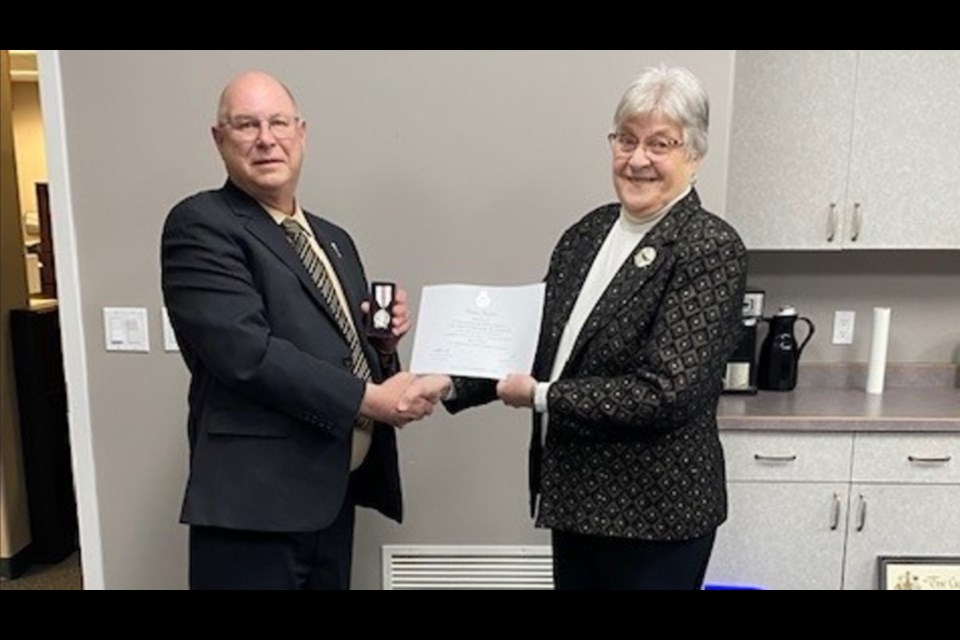 Rennie Harper, right, received a Queen Elizabeth Platinum Jubilee medals for her work in the community. Presenting the medal is Carrot River Valley MLA Fred Bradshaw.