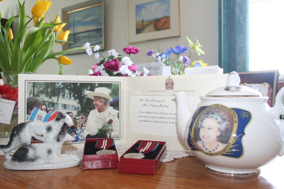 Kathryn Groshong’s collection of royal souvenirs, clippings, and photographs spans 77 years and says as much about the royals as it does about the time each piece is from. Her first royal item was the small porcelain statuette of two dogs, far left, which cost 25 cents and used to bear a royal emblem which has worn off over the years. Other items include letters of congratulations to her and her husband, Fred, from the palace for their 60th and 65th wedding anniversaries, and royal service medals for both Fred and Kathryn given the year of the queen’s Diamond Jubilee to thank the Groshongs for their many years of community service.