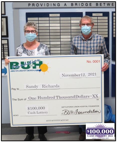 Sandy and Deryl Richards accepting their winnings from the grand prize draw of the BUH  Lottery Foundation.